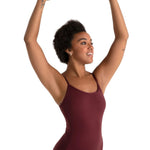 Woman wearing a maroon leotard against a white background