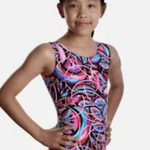 Young girl wearing a colorful leotard 
with a pattern on a plain background