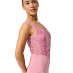 Person wearing a pink ballet leotard on a white background