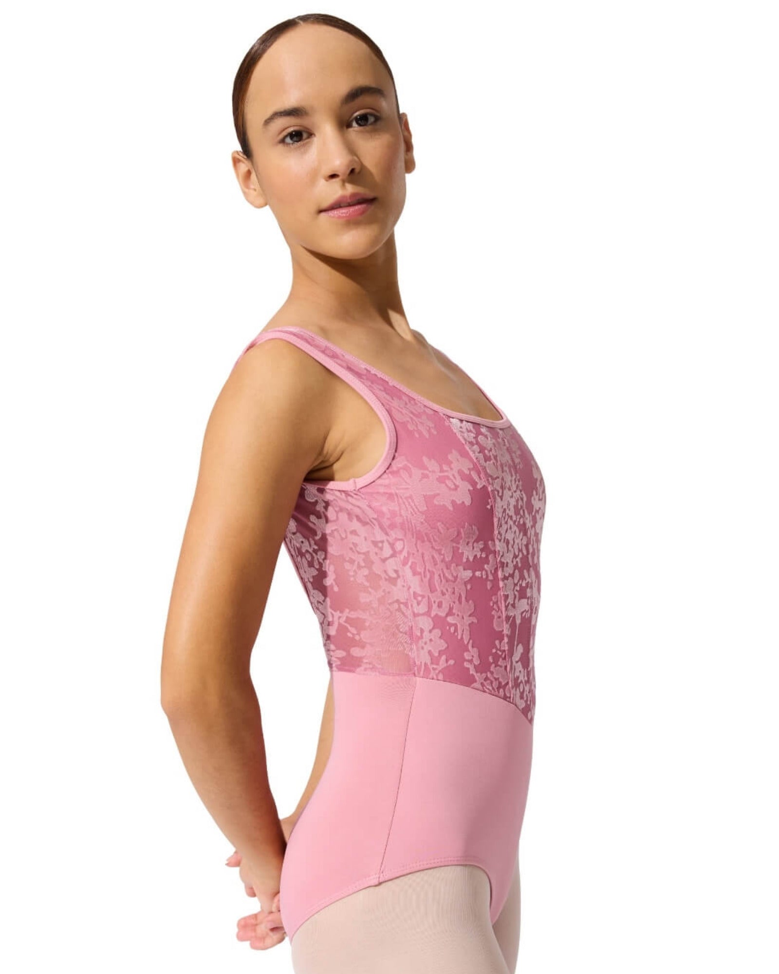 Person wearing a pink ballet leotard on a white background