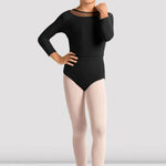 Young girl wearing a black leotard and pink tights on a white background