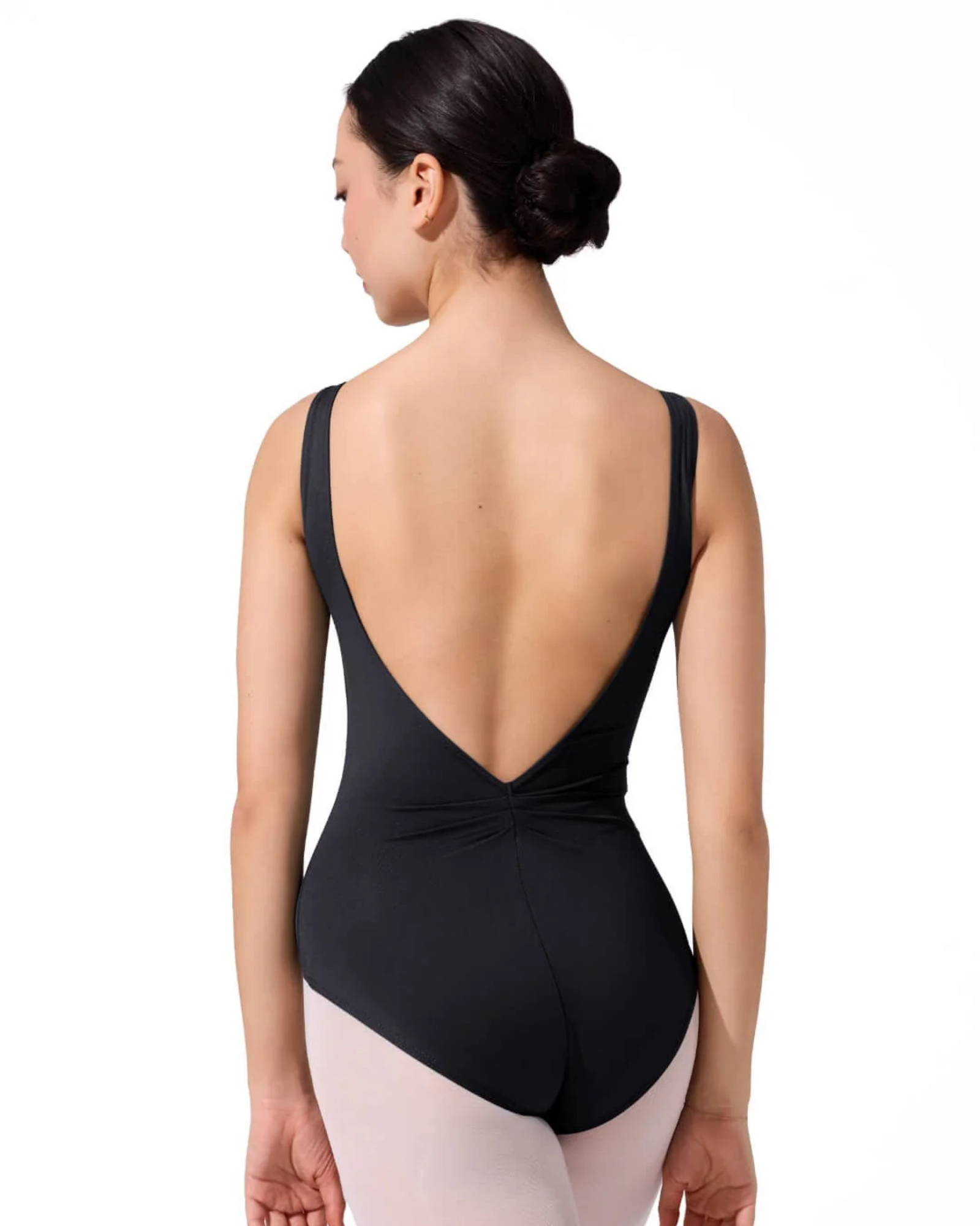 Black leotard with open back worn by a dancer on a white background