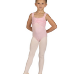 Young girl in a pink ballet leotard and beige tights on a white background
