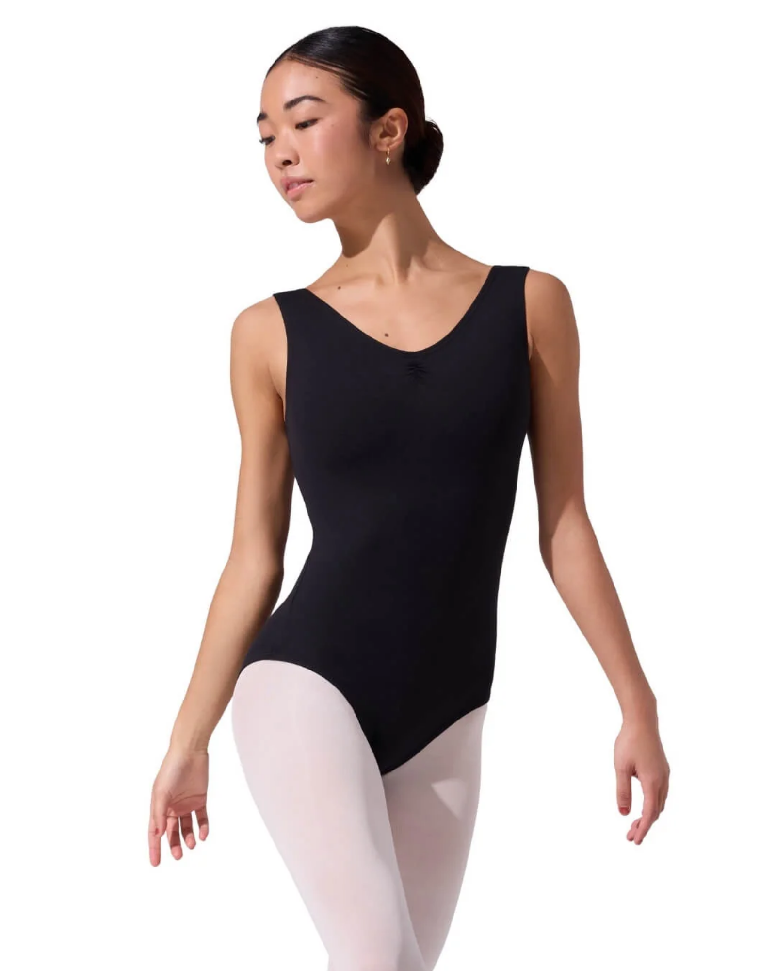 Person wearing a black tank leotard and white tights on a white background