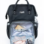 Backpack with contents on display on a plain background