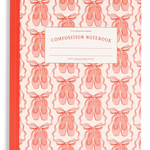 A composition notebook with a coral pink and white ballet shoe pattern cover, a solid coral pink spine, and a white label on the front reading 'COMPOSITION NOTEBOOK'.