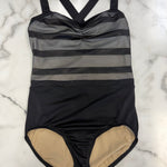 A leotard laid flat on a white marble surface. The leotard features a black and gray striped bodice with sheer horizontal mesh stripes, a ruched center, and a solid black skirt.