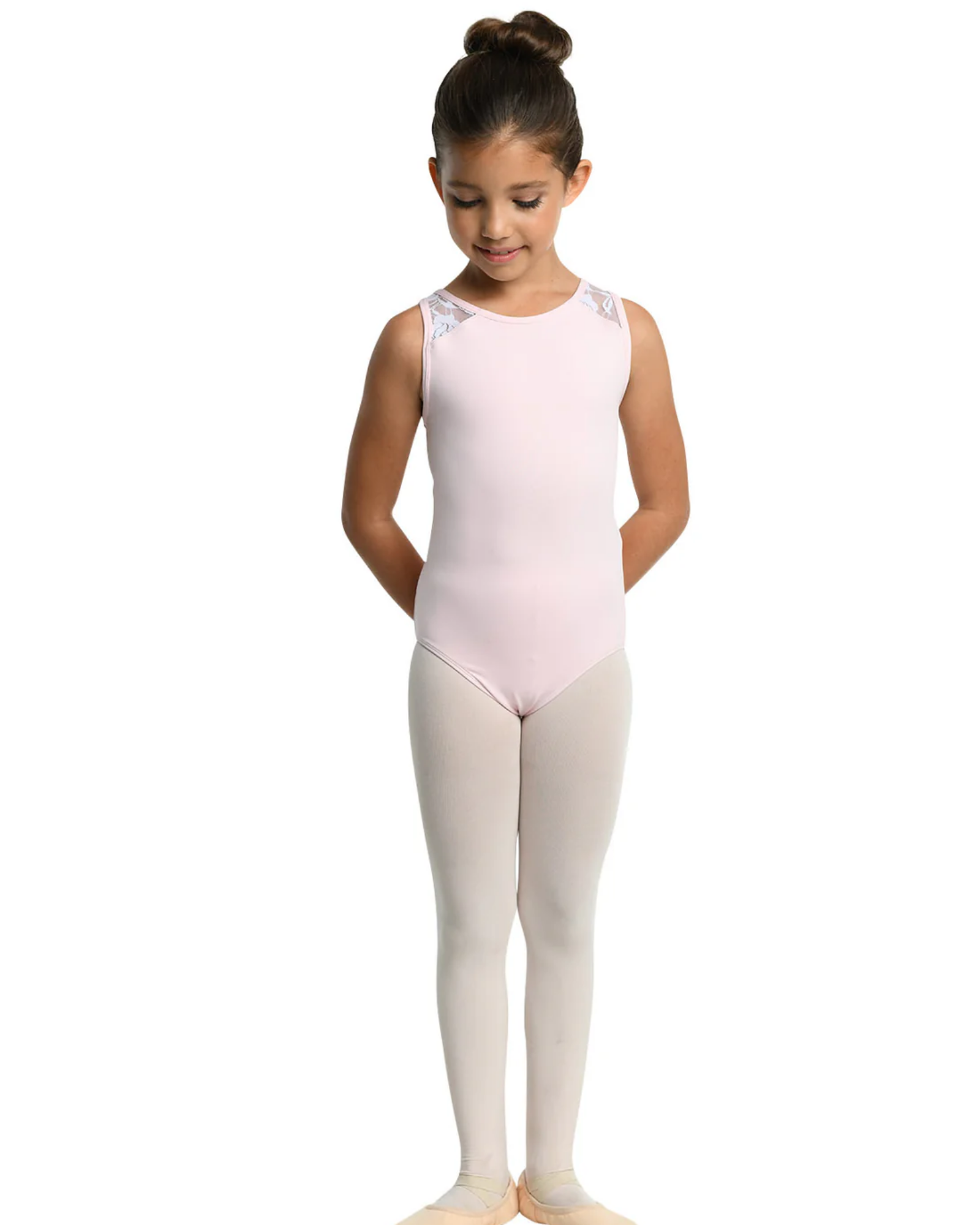 Young girl in a pink leotard and white tights on a white background