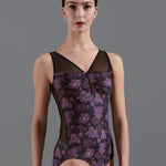 Model wearing a floral-patterned leotard against a gray background