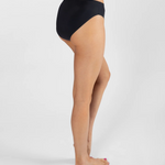 Person wearing a black high-waisted bikini bottom on a white background