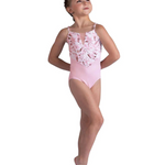 Young girl in a pink floral leotard on a white background
