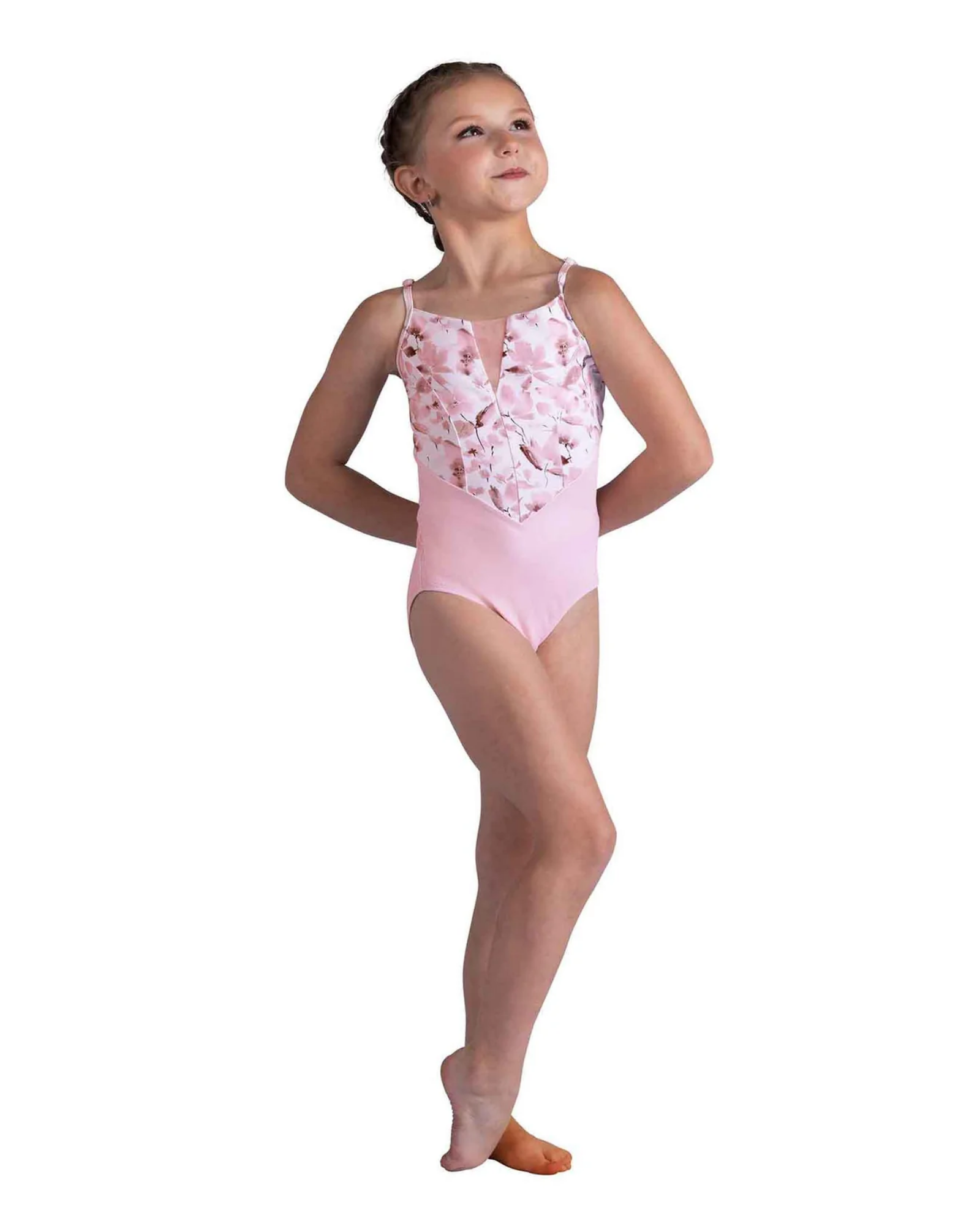 Young girl in a pink floral leotard on a white background