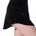 Black velvet skirt worn by a person on a white background