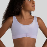 Woman wearing a lavender bra top against a plain background