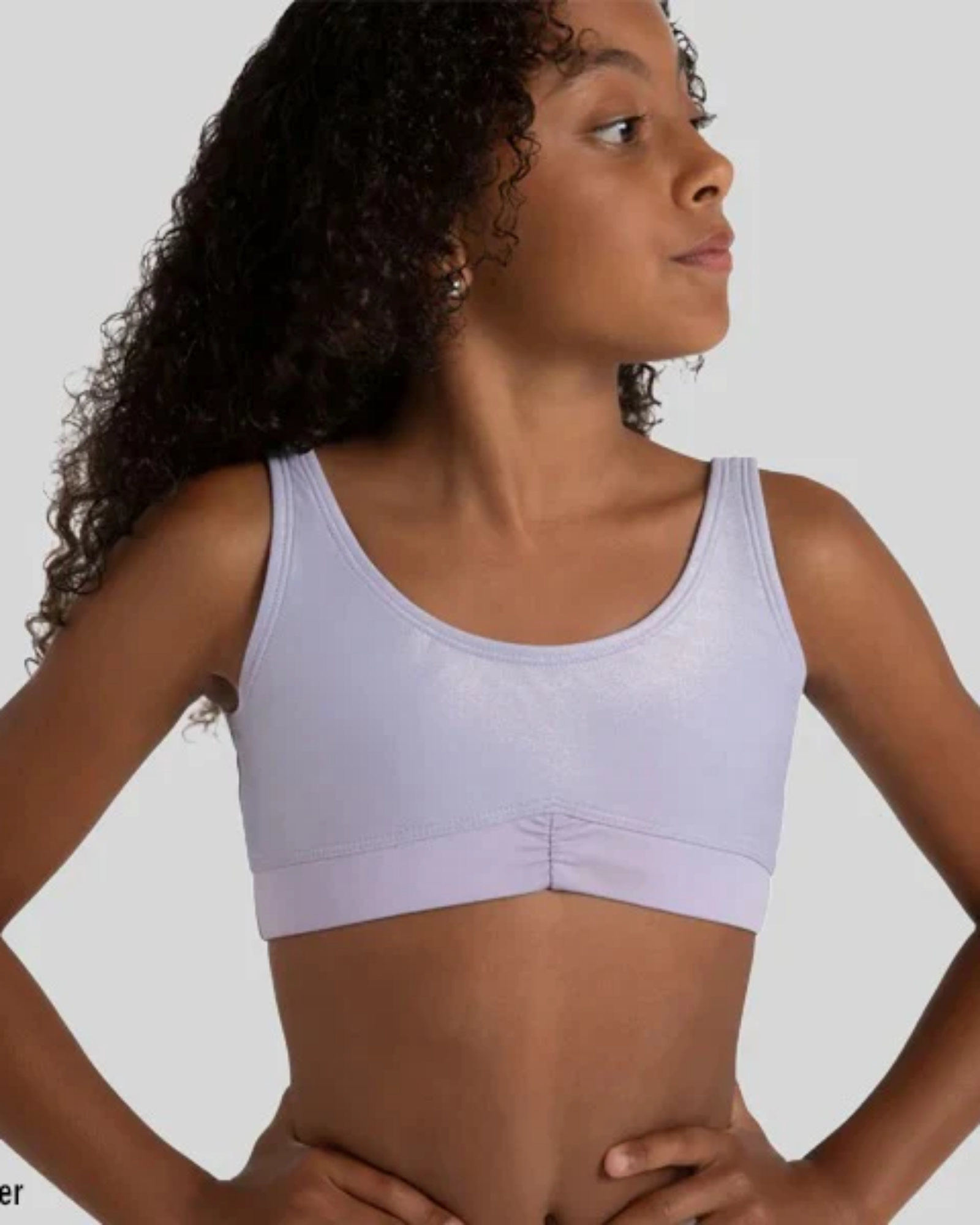 Woman wearing a lavender bra top against a plain background