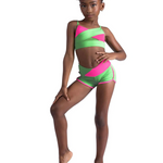 Young girl wearing a pink and green dance outfit on a white background