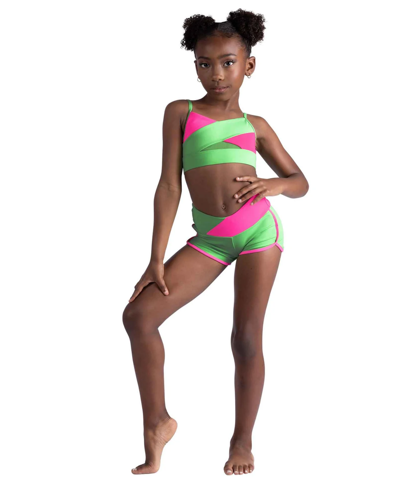 Young girl wearing a pink and green dance outfit on a white background