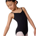 Young girl in a black leotard and white tights on a white background