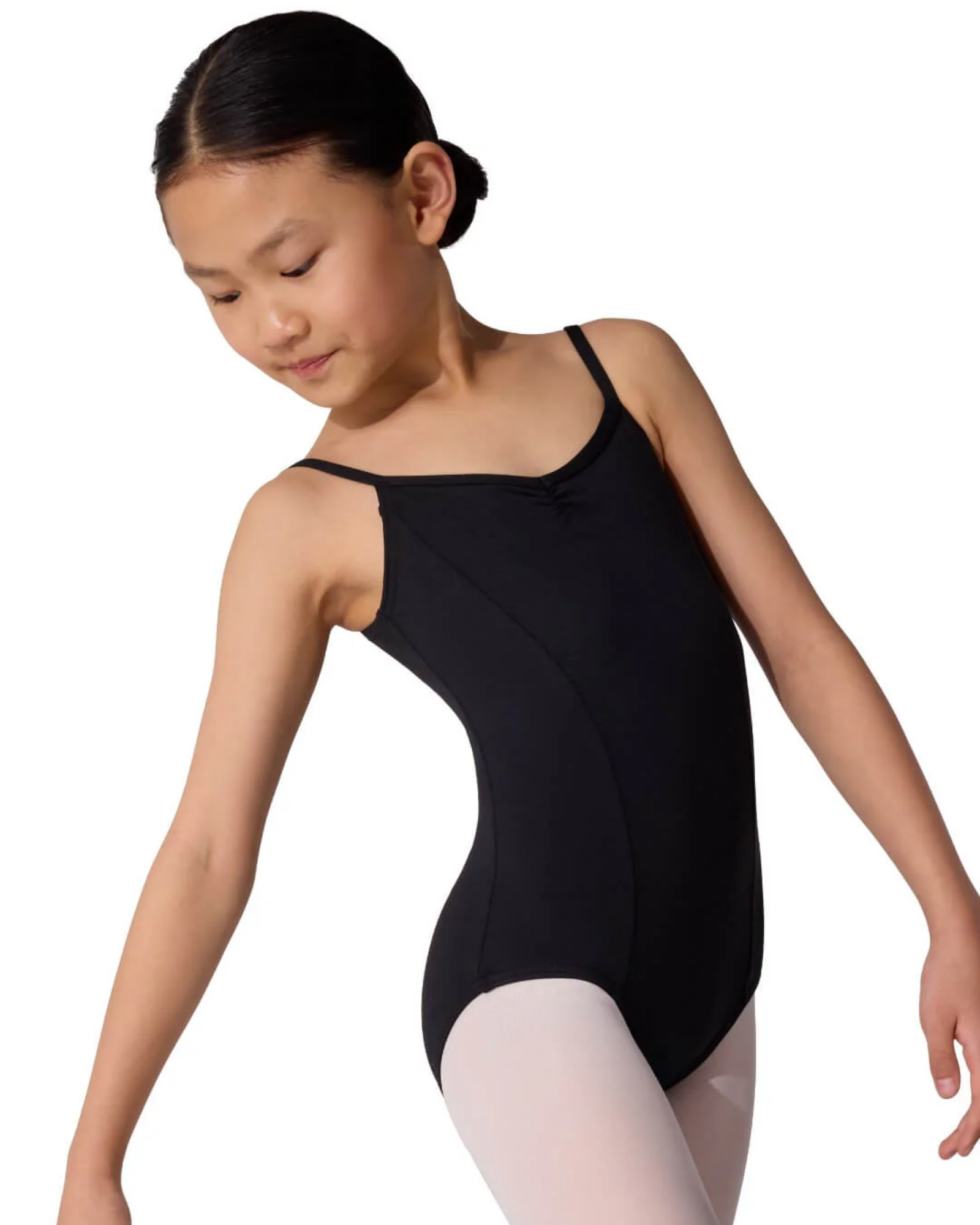 Young girl in a black leotard and white tights on a white background