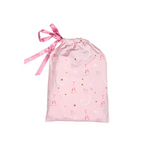 A light pink drawstring gift bag with a satin pink ribbon tied at the top, decorated with a whimsical print of ballerina figures, crescent moons, stars, and small gold dots.
