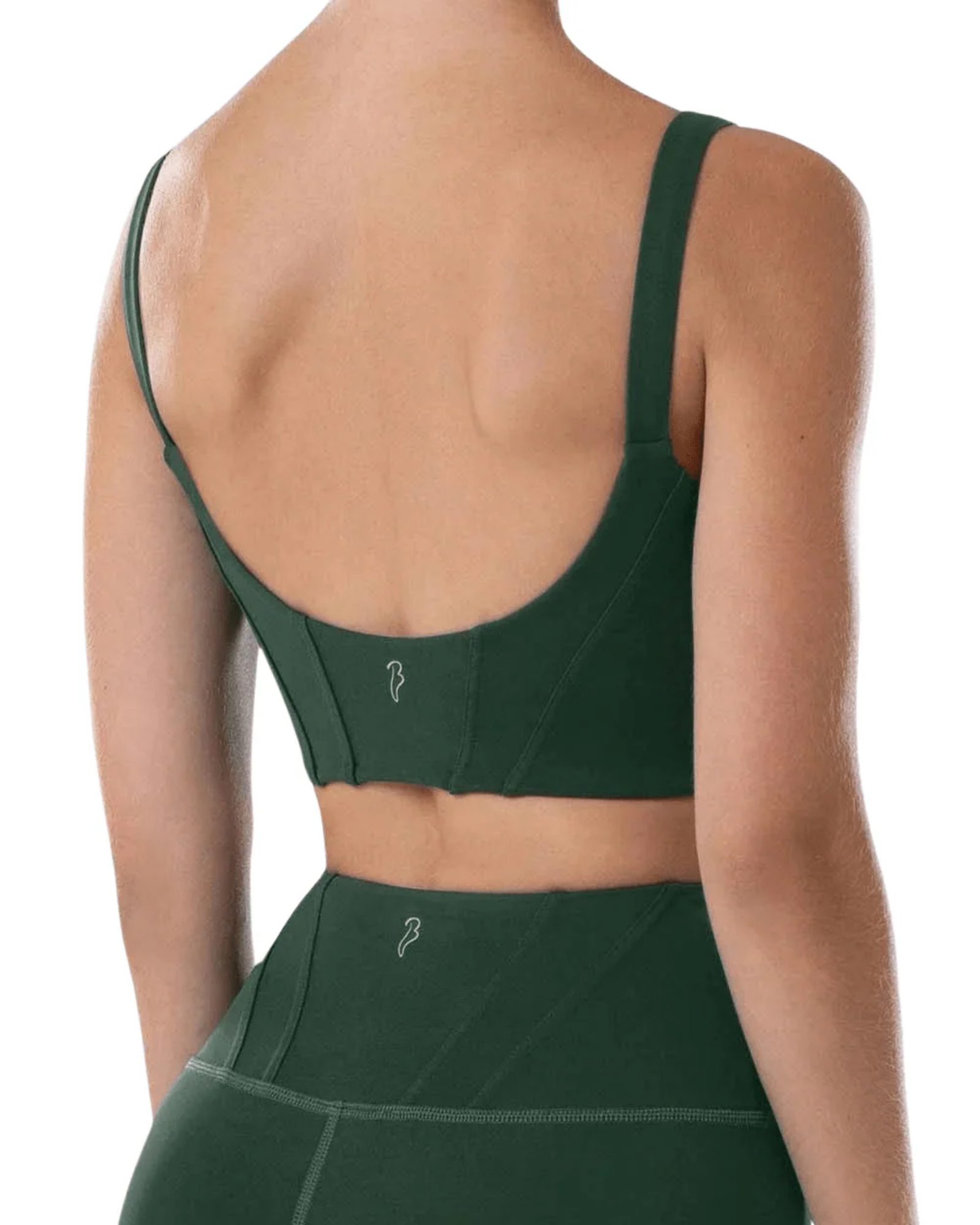 A woman shown from the back wearing a dark green dance bra and matching high-waisted leggings against a plain white background.