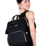 Woman wearing a black backpack with visible branding on a white background