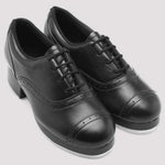 Pair of black leather shoes on a light gray background