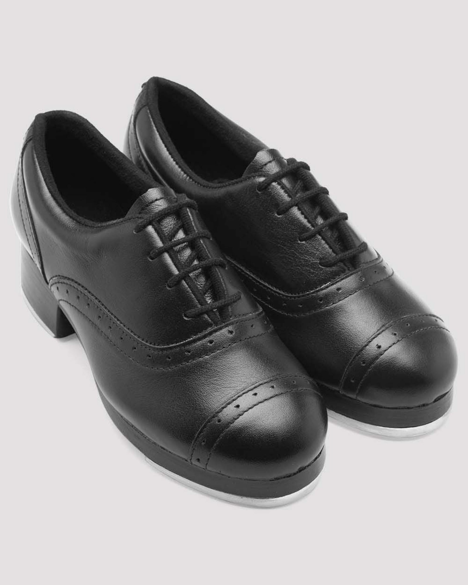 Pair of black leather shoes on a light gray background