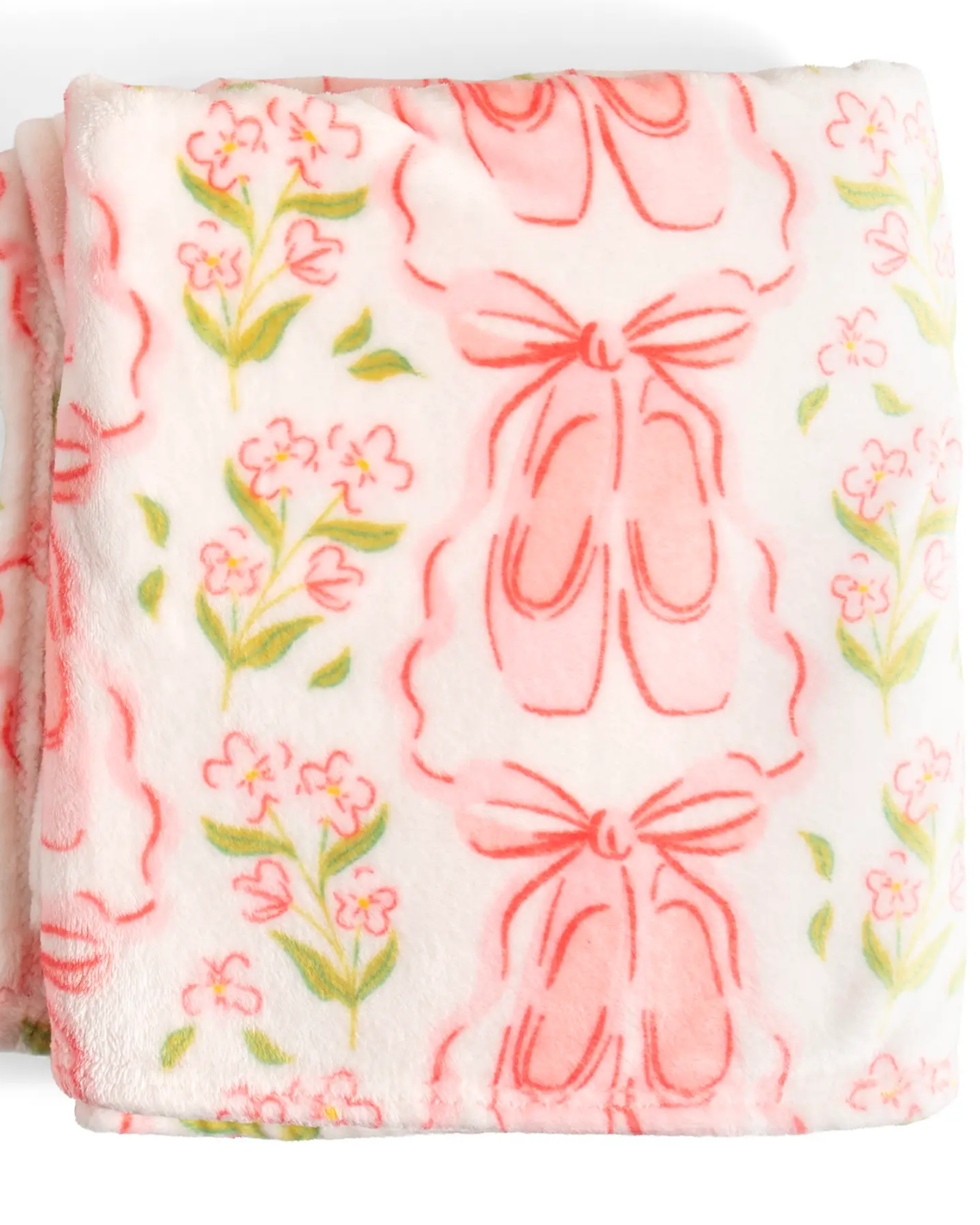 A folded plush blanket featuring a pattern of pink ballet shoes and green floral stems on a white background.