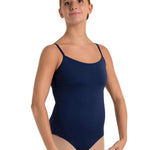 Person wearing a navy blue swimsuit with thin straps on a white background