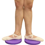 Person wearing ballet shoes on purple balance disks with a white background