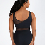 Woman wearing a black leotard with mesh panels on a white background