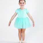 A young girl modeling a light mint green short-sleeve tutu dress with a matching headband and ballet slippers, standing against a plain white studio background.