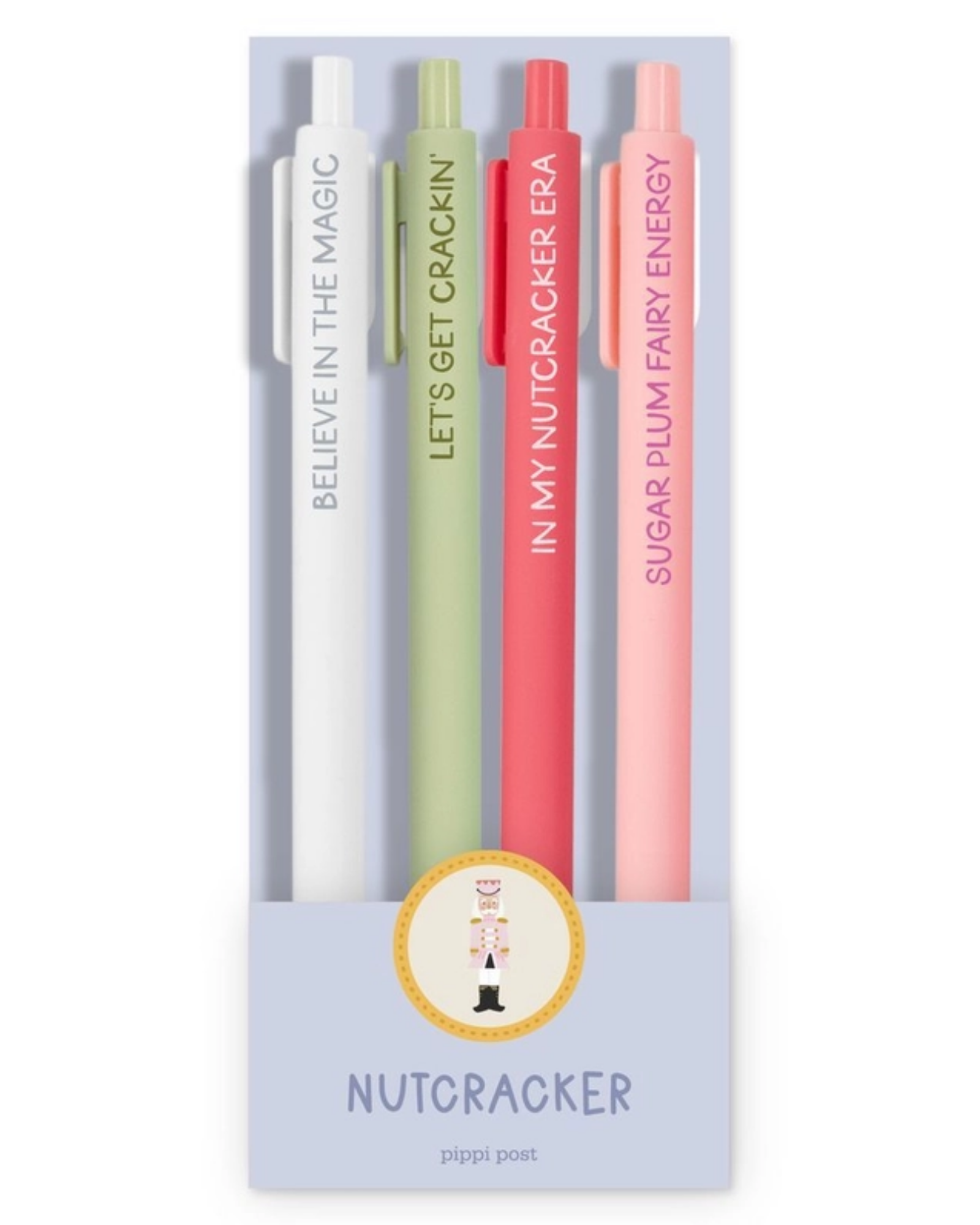 Four slim pens in pastel white, sage green, coral red, and light pink, displayed in a clear vertical card package. Each pen has a different fairy-themed phrase printed vertically: 'BELIEVE IN THE MAGIC,' 'LET'S GET CRACKIN'', "IN MY NUTCRACKER ERA", SUGARPLUM FAIRY ENERGY".