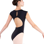Ballerina wearing a black leotard with cut-out design on a white background