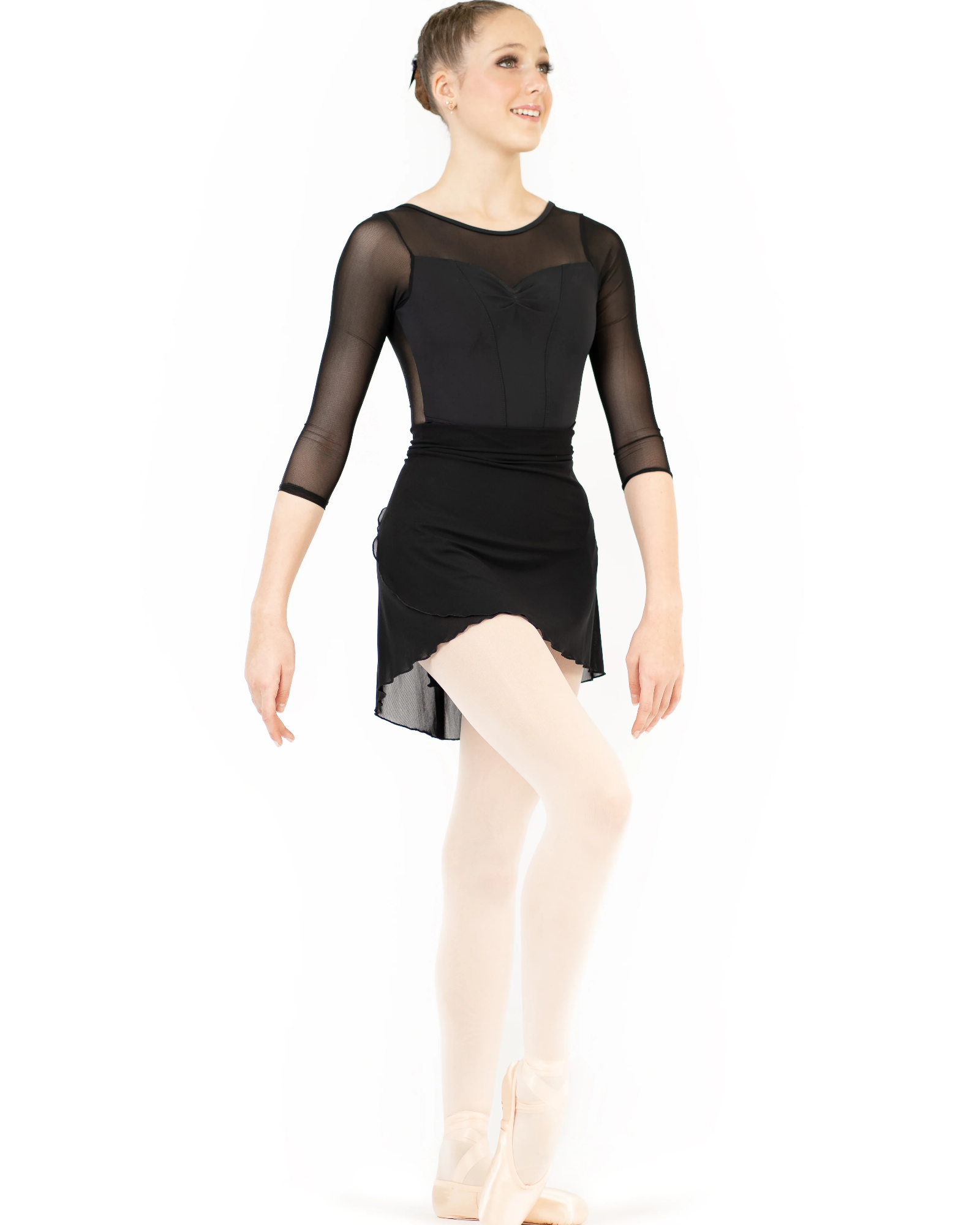 Dancer in a black leotard and beige tights on a white background
