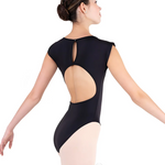 Ballerina wearing a black leotard with cut-out design on a white background