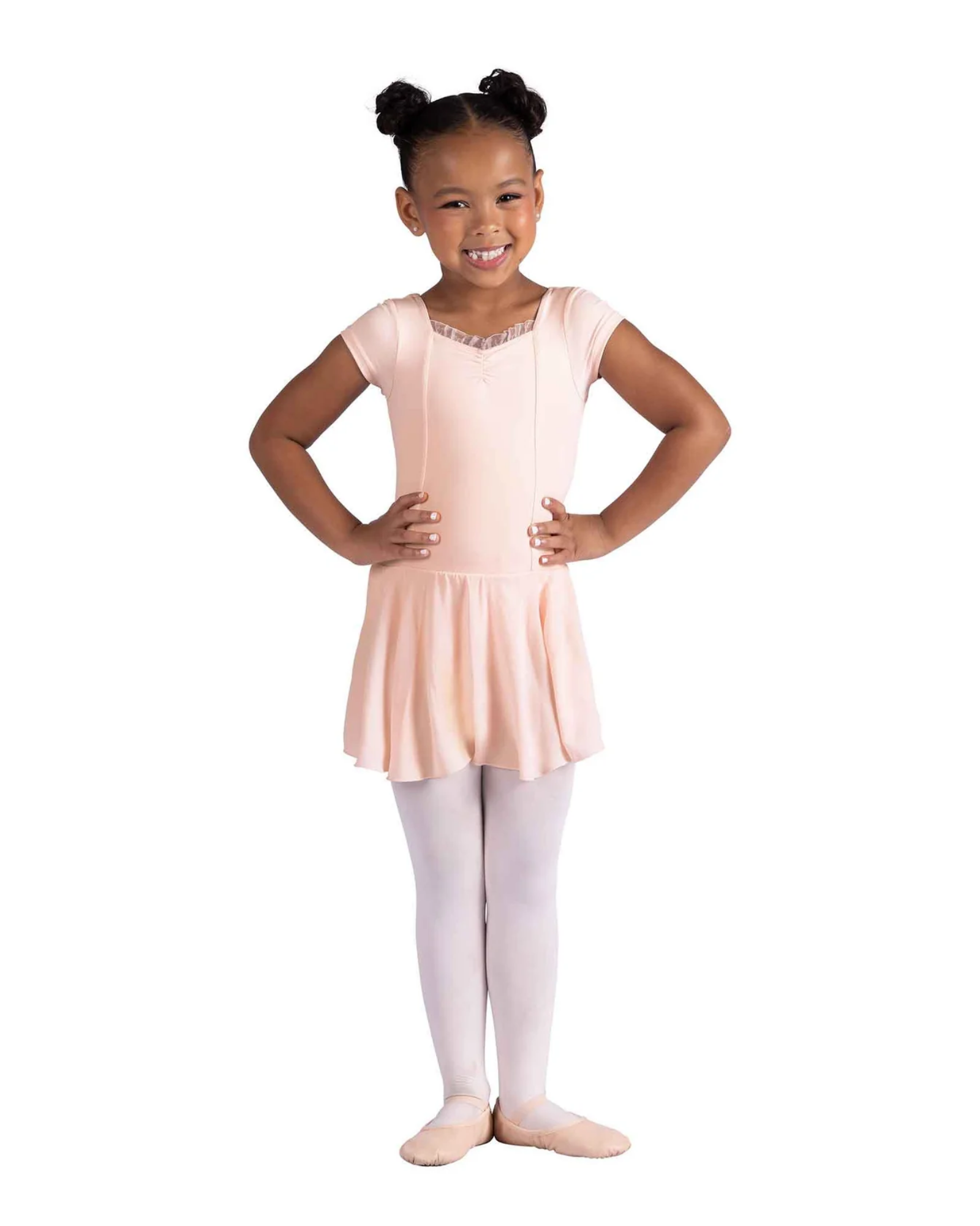 Young girl in a pink ballet dress and white tights on a white background