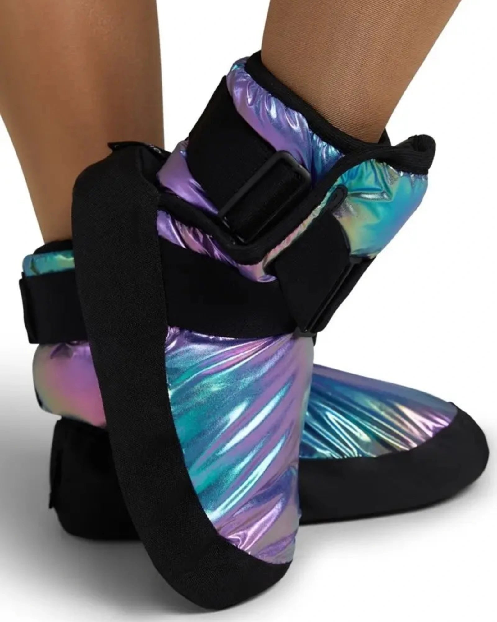 A pair of ankle support boots with black straps and a holographic, iridescent finish shifting between purple, blue, and green, shown on a model's feet against a white background.
