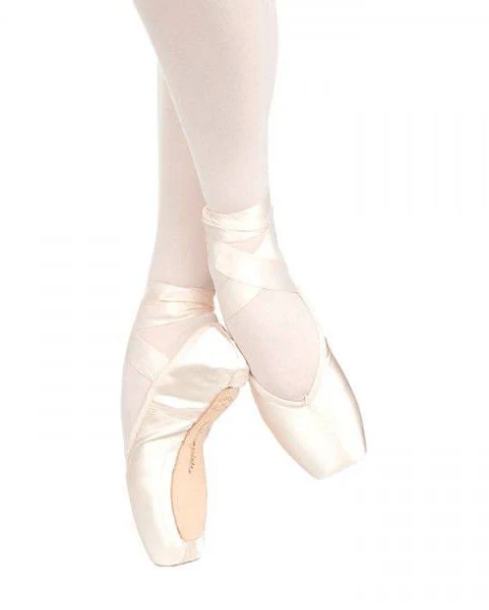 A pair of satin pointe shoes worn on a dancer's feet, paired with light pink tights against a solid white background.
