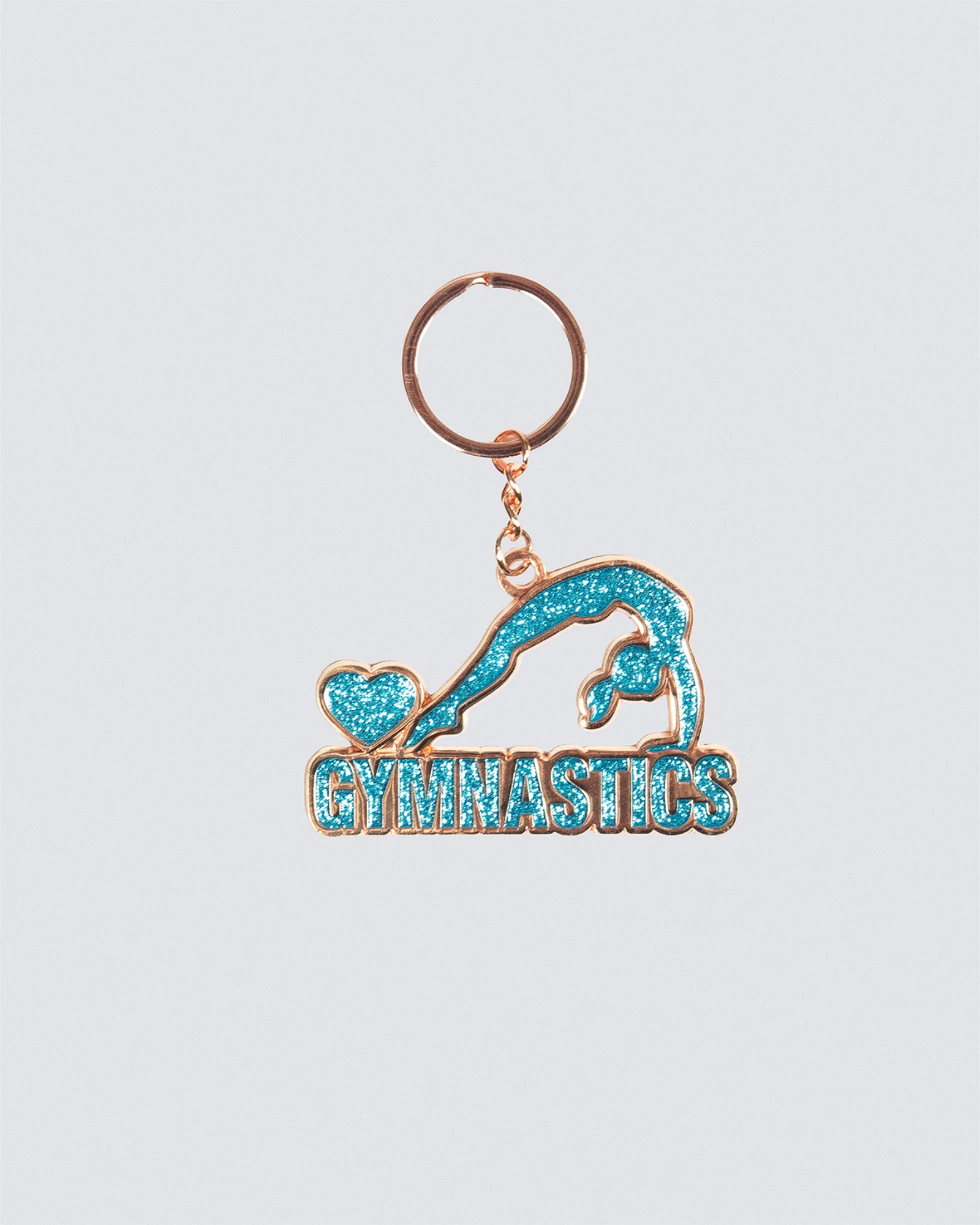 Gymnastics-themed keychain with a blue gymnast design on a light gray background