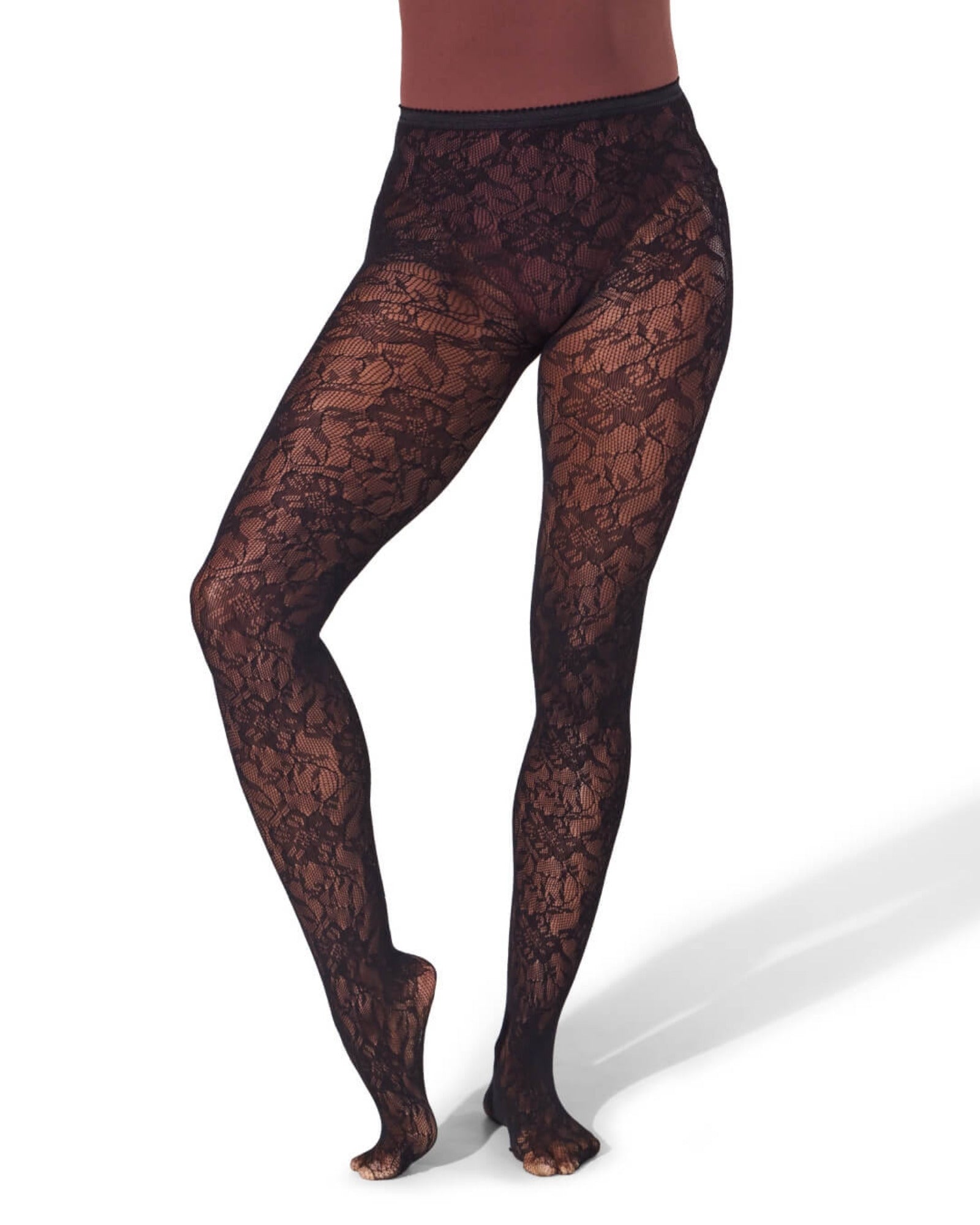 Black lace tights worn by a person on a white background
