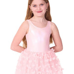 Young girl wearing a pink ballet dress with a tutu on a white background