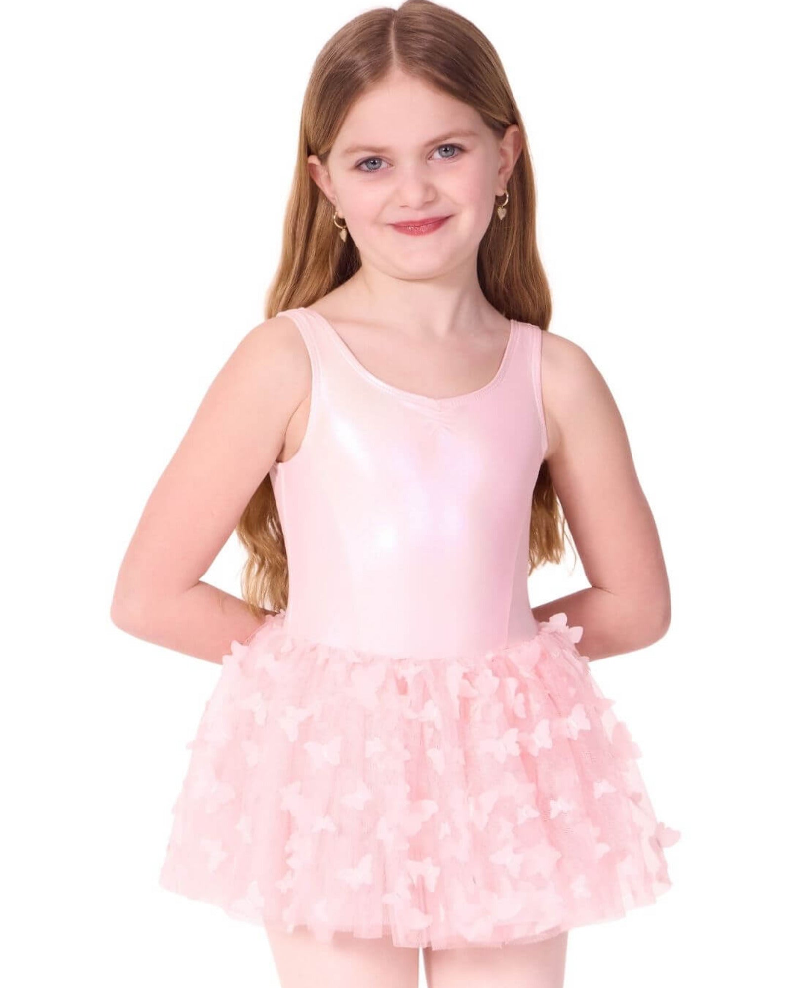 Young girl wearing a pink ballet dress with a tutu on a white background