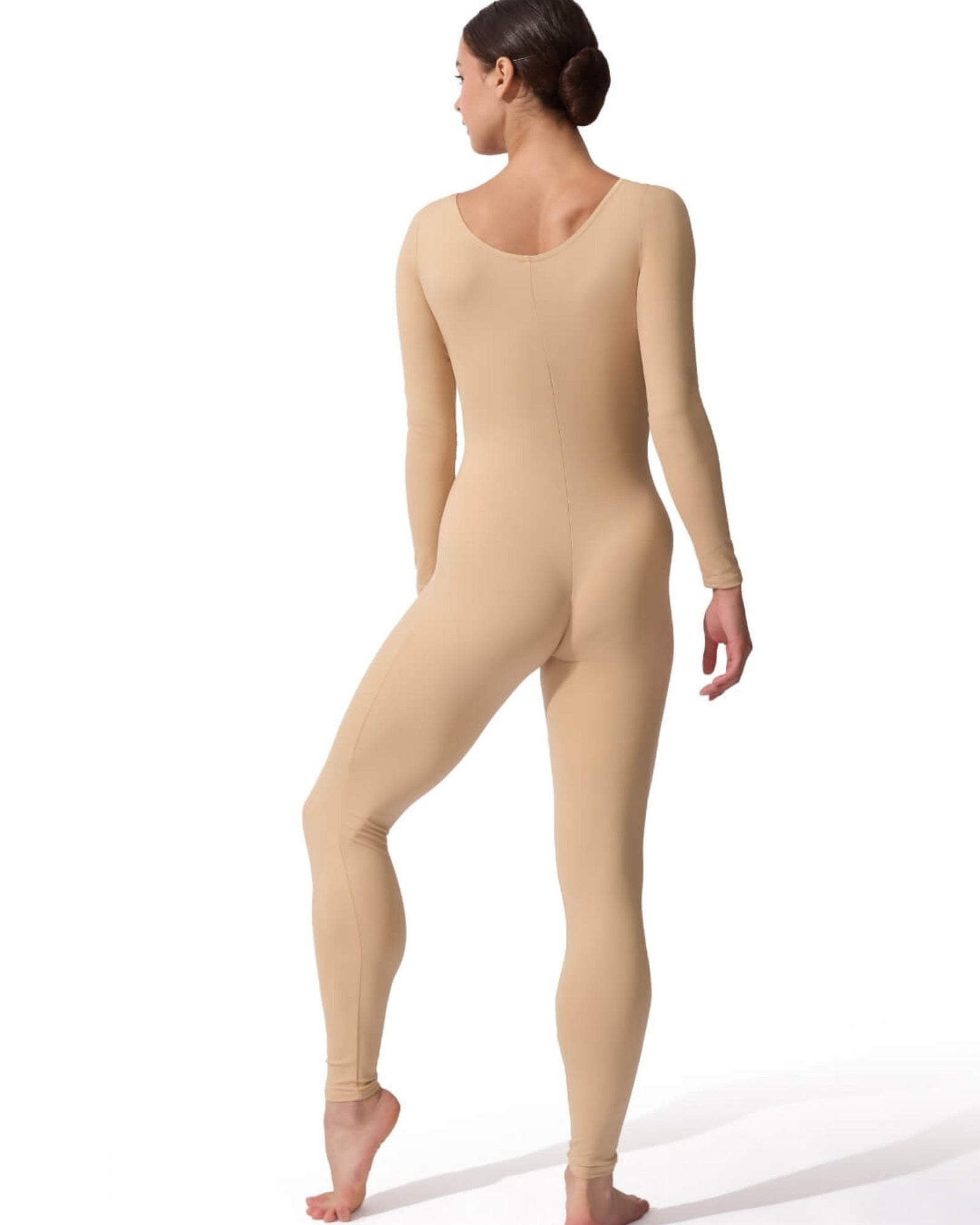 Person wearing a beige bodysuit on a white background