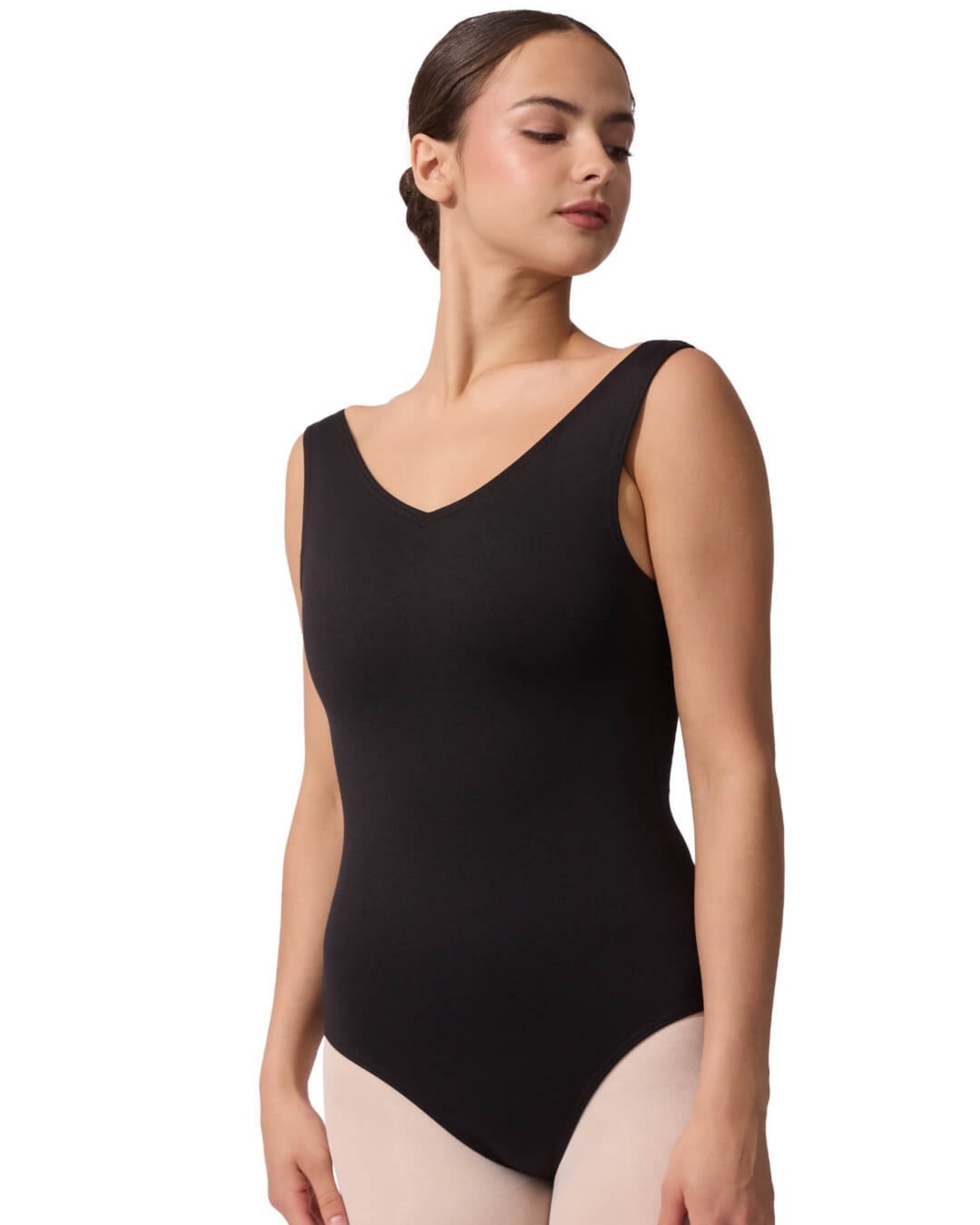 Woman wearing a black leotard on a white background