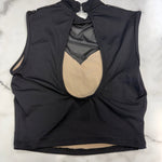 A black sleeveless dance top with a high mock neck and a keyhole open back, shown flat on a white marble surface. Inside is lined in beige.