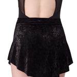 Black velvet skirt worn over a black mesh top on a white background