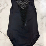 A black sleeveless leotard with a sheer mesh V-neckline and textured black mesh panel, laid flat on a white marble background.