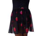 Black skirt with pink strawberry patterns on a white background